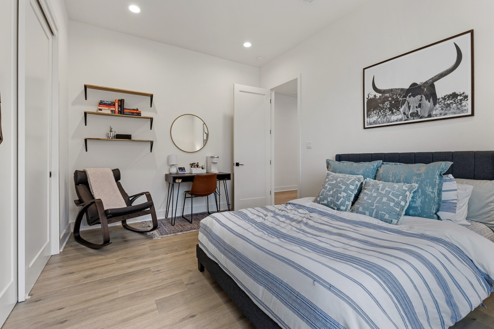 Bedroom 4 with blue-stripe bedding, longhorn wall art, shelves and study nook