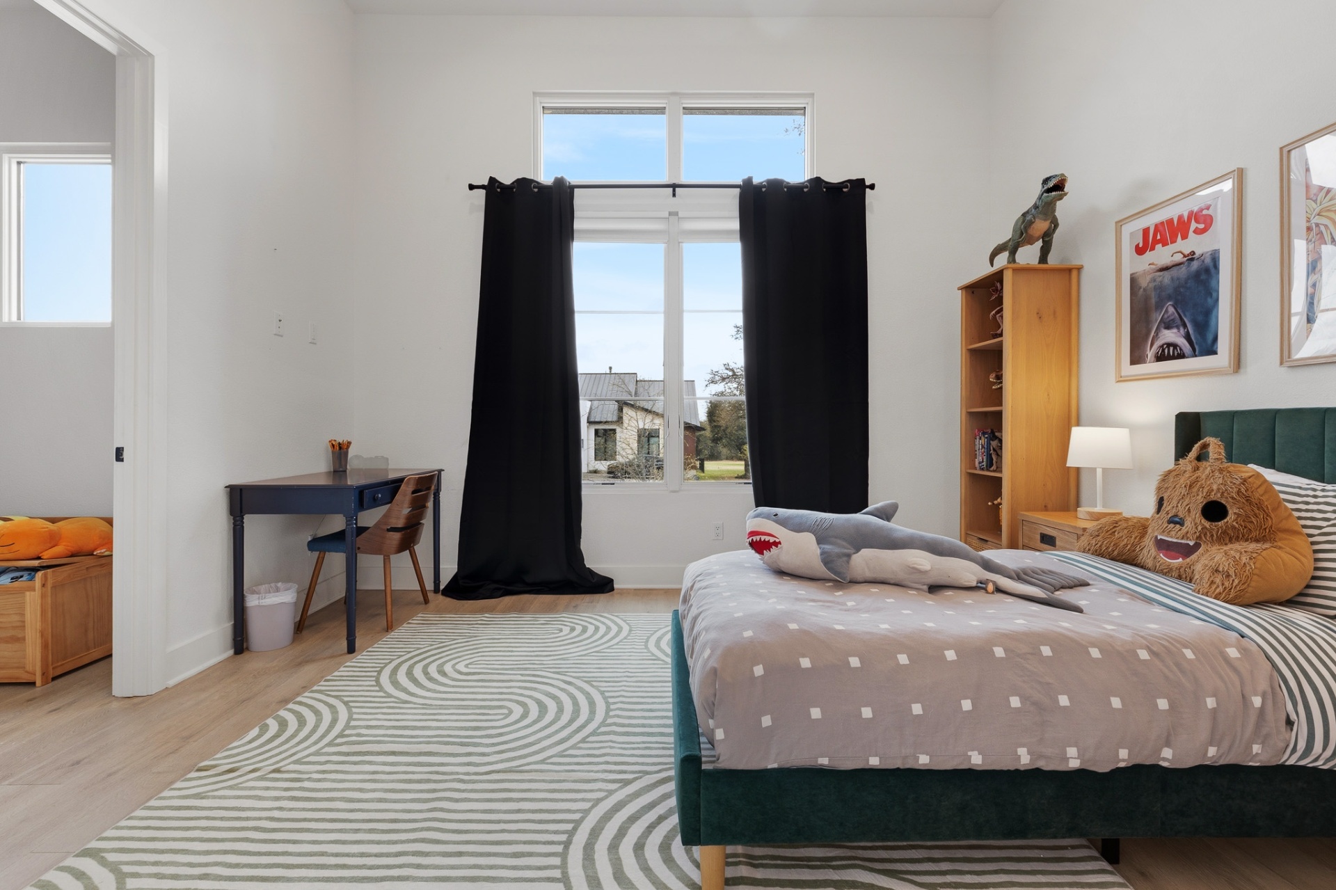 Bedroom 5 angle — navy desk, stuffed shark, Jaws poster and view to closet