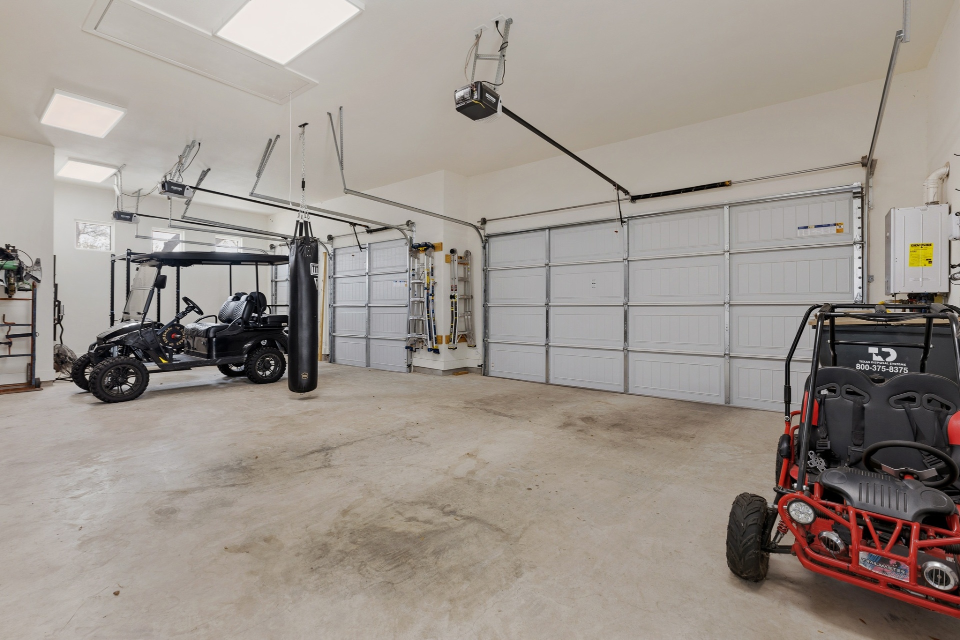 4-car garage wide — golf cart, go-karts, punching bag, dual openers and tankless water heater