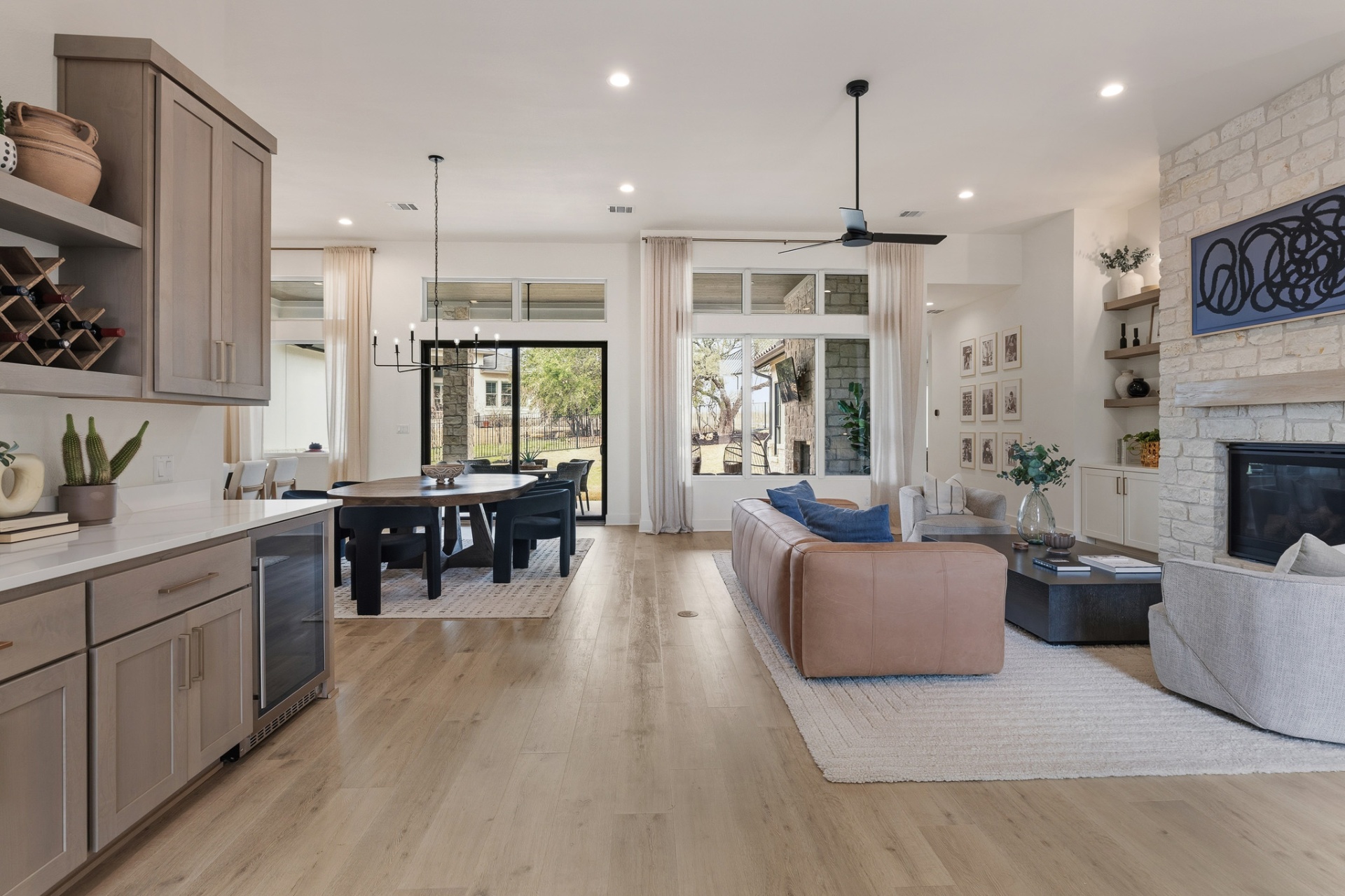 Wet bar, dining and living area — wine rack, steel entry door, patio doors and stone fireplace